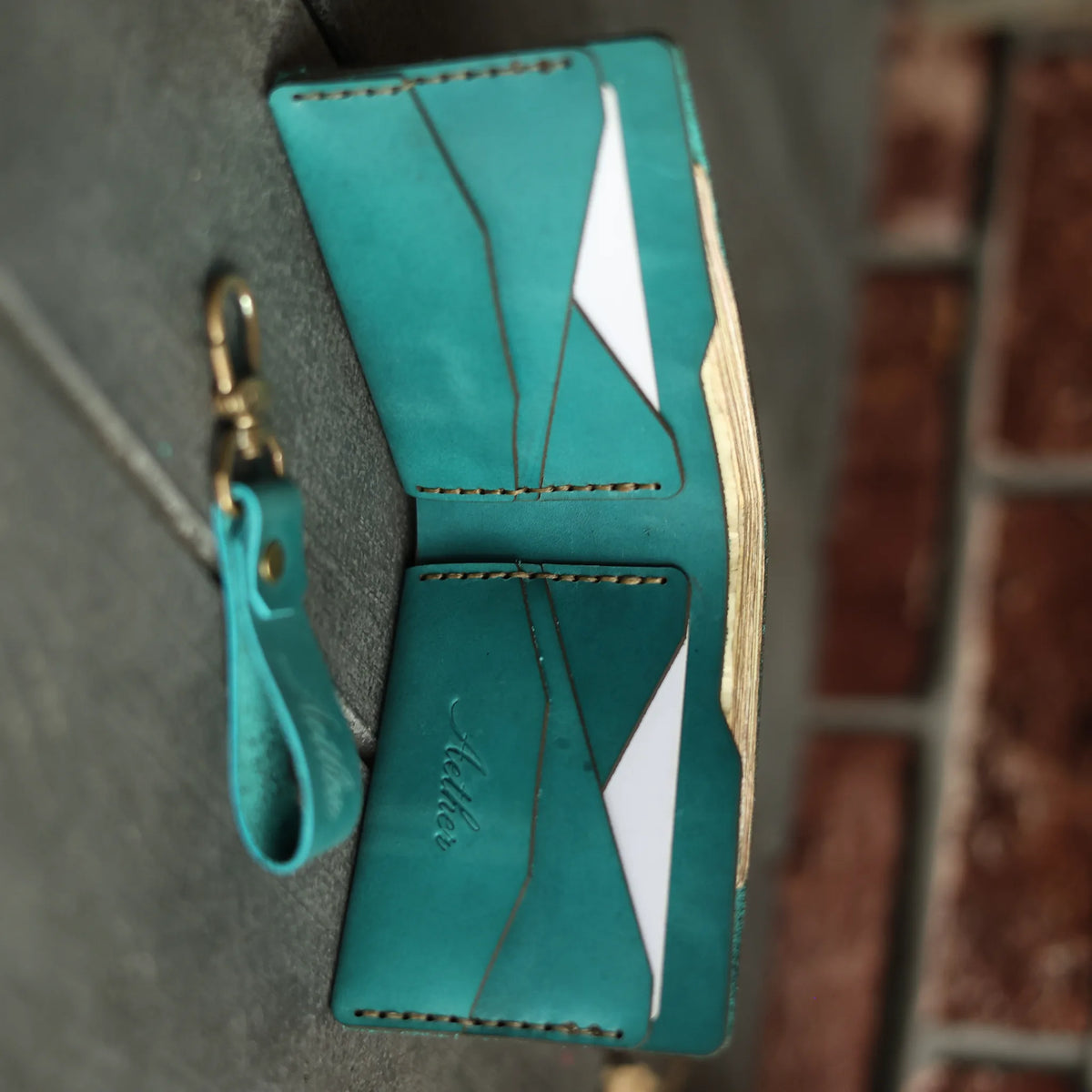 Aether blue leather bifold wallet open showing card pockets